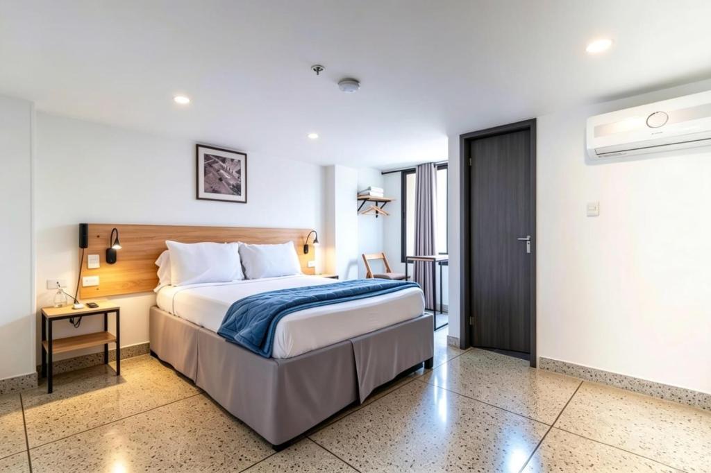 a hotel room with a bed and a desk at Bianco Hotel Boutique in Cúcuta