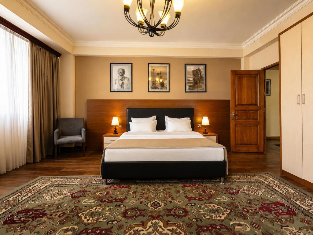a hotel room with a bed and a chandelier at Cathedral Plaza Hotel in Gyumri