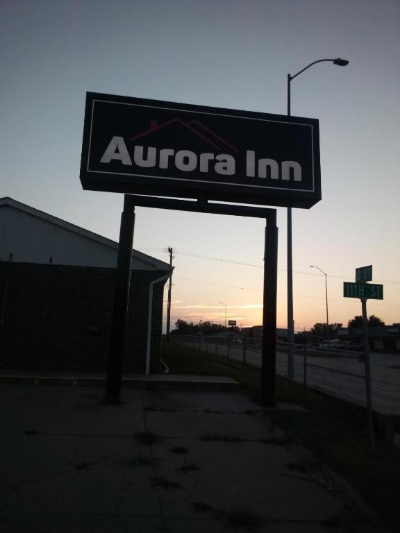 a sign for an autoco inc store on a street at Aurora Inn in Aurora