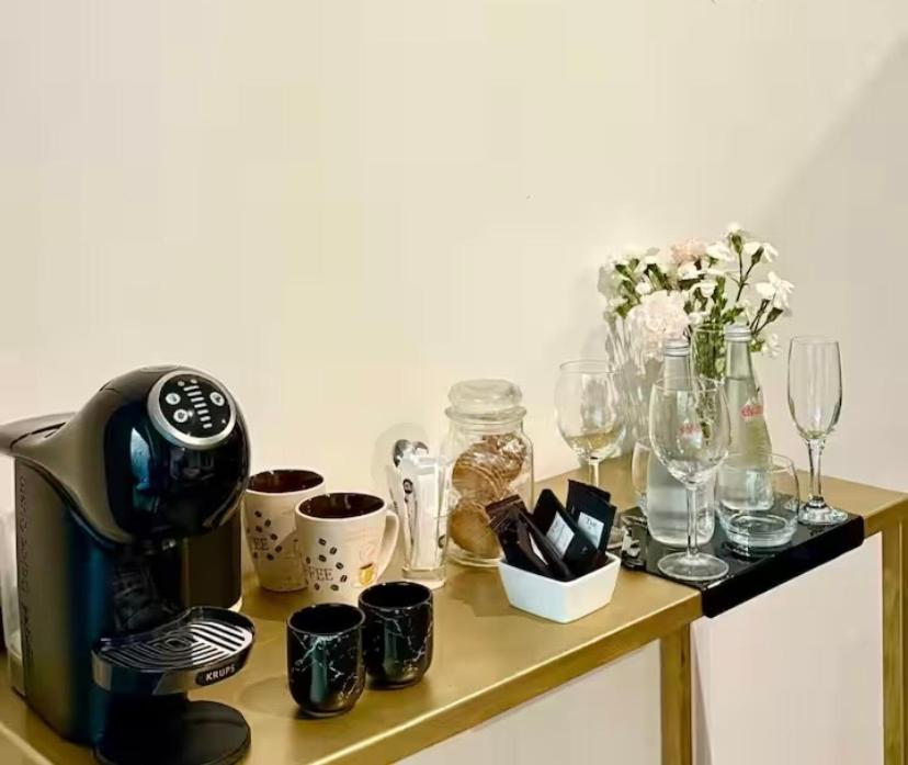 a table with a coffee maker and glasses on it at Une Parenthèse in Barbentane