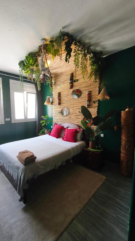 a bedroom with a bed with plants on the wall at Premium Flat Agadir - Immersive rental --- Maison Bleue --- Fast wifi in Agadir