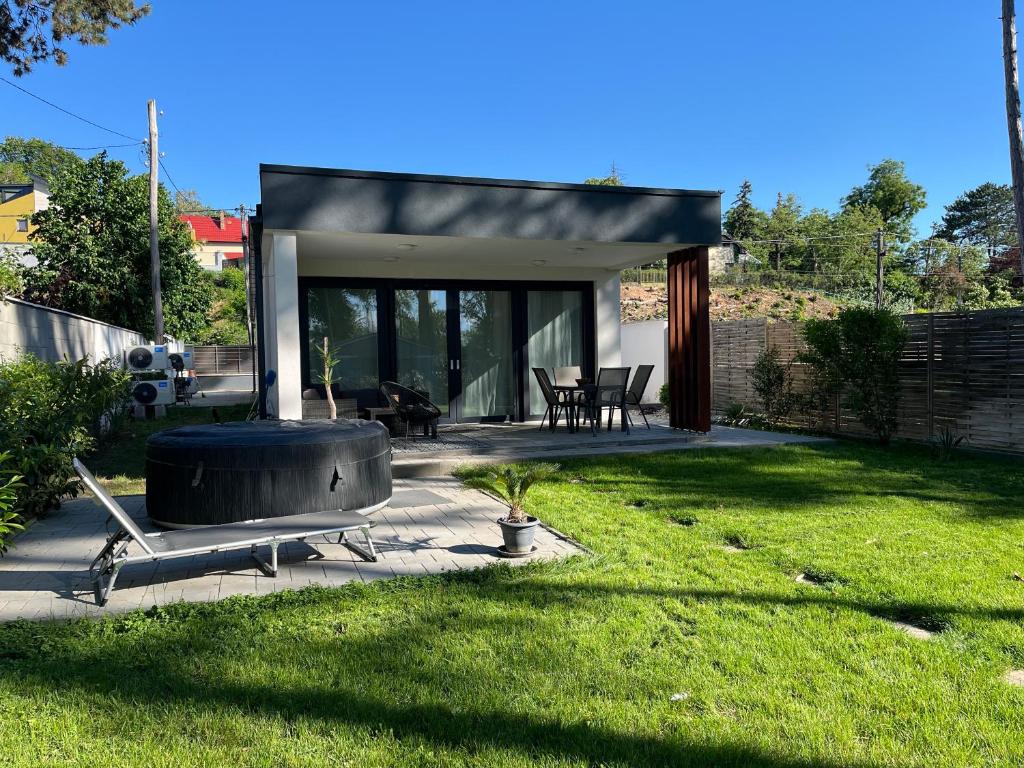 a backyard with a hot tub in the grass at Ala'Toboz Siófok in Siófok