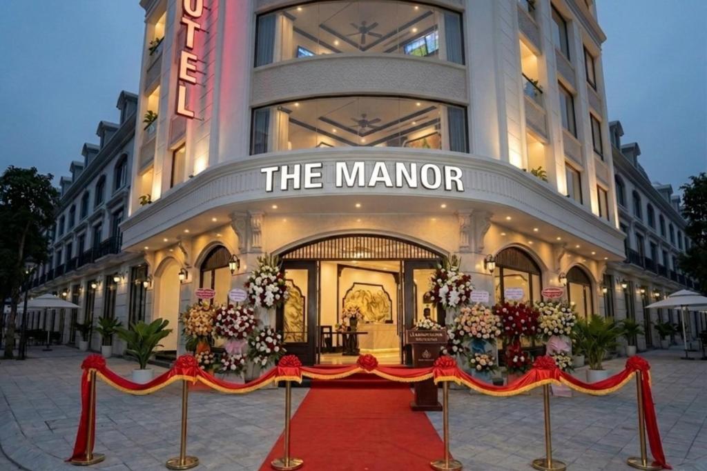 a red carpet in front of a manor building at The Manor Hotel in Nam Ðịnh