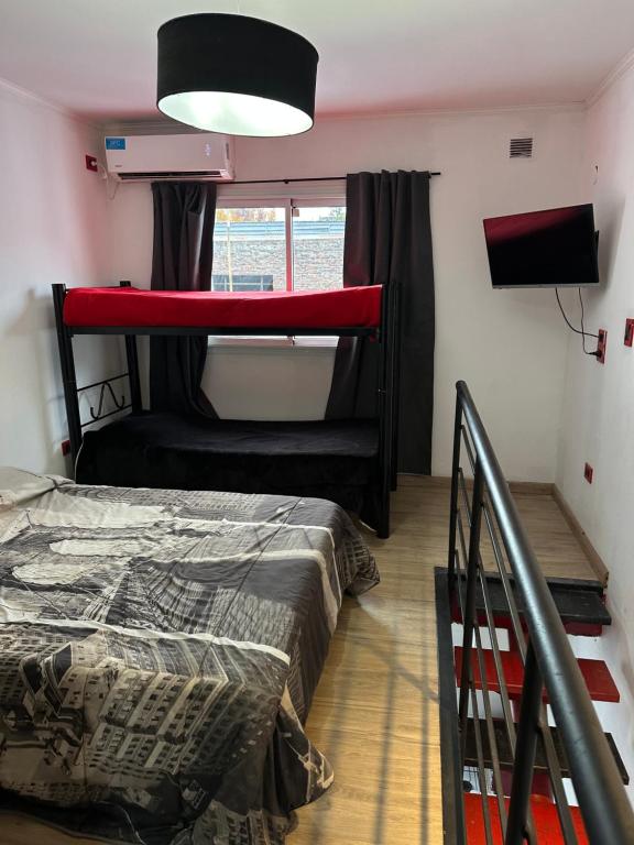 a bedroom with a bunk bed and a window at Mini casita a in Rosario