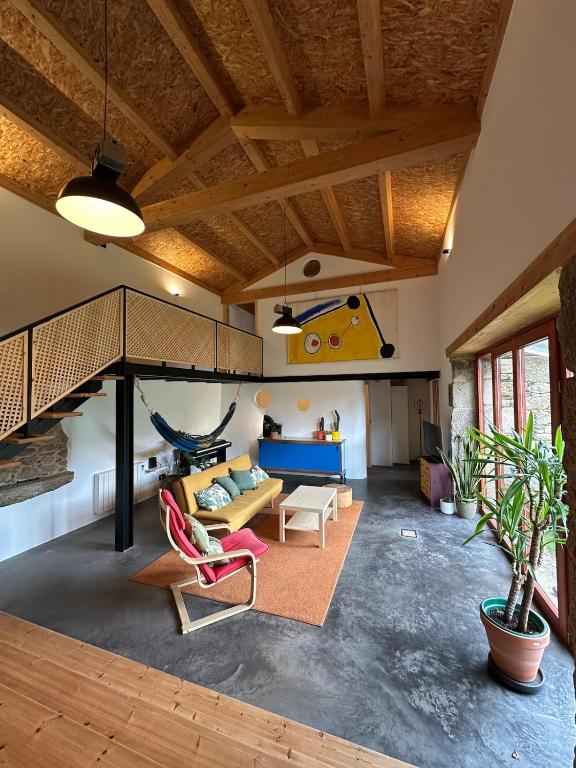 a living room with a couch and a swing at PASENIÑO - Aloxamento rural in Palas de Rei