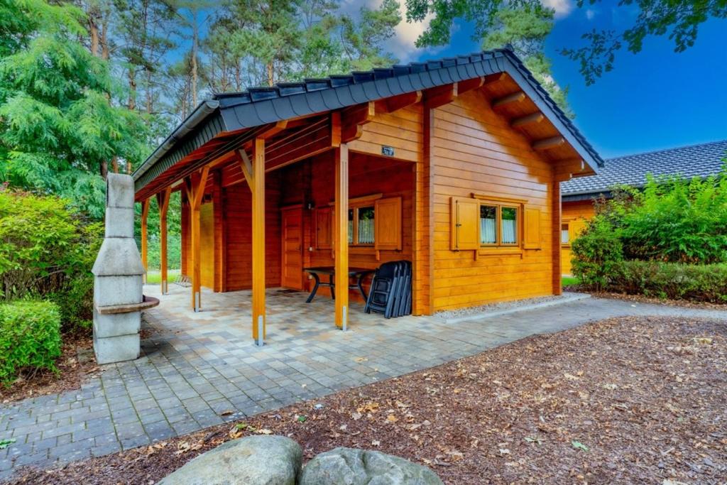a log cabin with a patio in front of it at Waldsiedlung - Haus 9 in Senftenberg