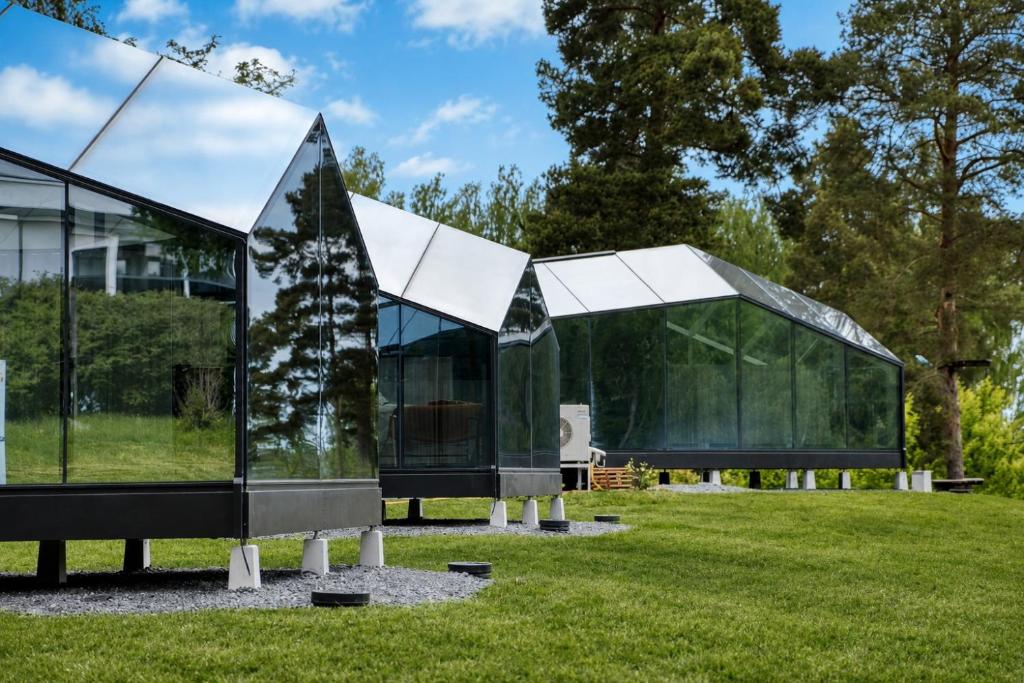 two glass houses on a grassy field at Lunar Igloos - Lumi in Karkku