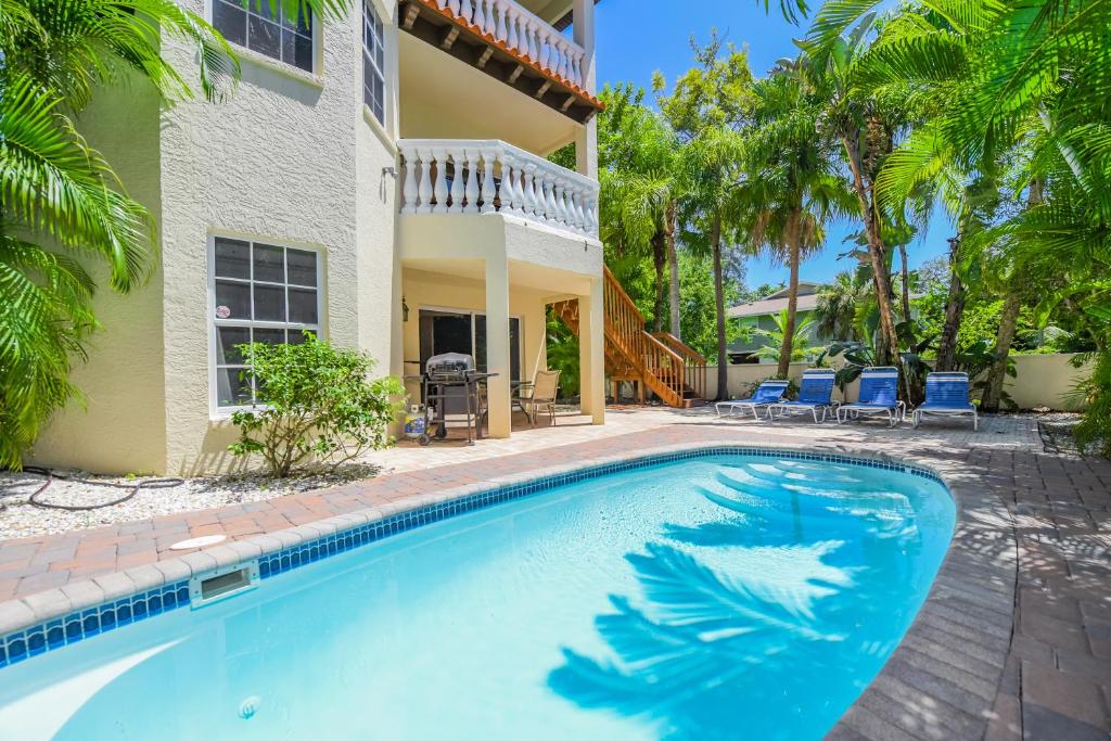 a swimming pool in front of a house at Villa Florence in Holmes Beach