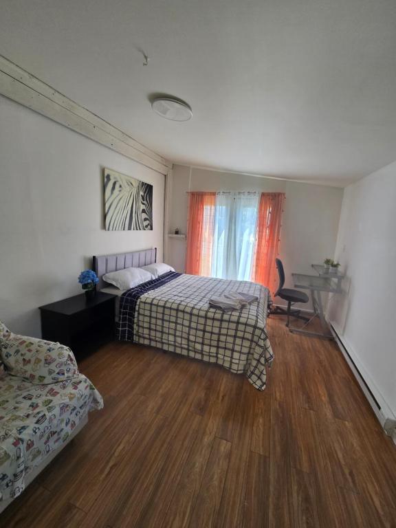 a bedroom with a bed and a desk and a chair at Brossard room 3 in Brossard