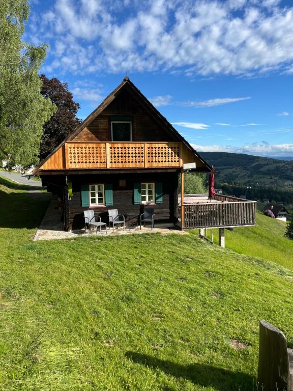 a log house on a hill with a deck at Ferienhaus Trausibauer in Stainz
