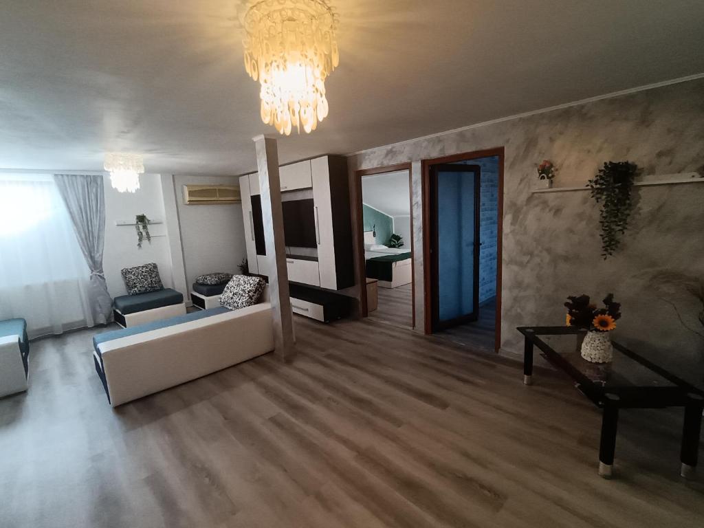 a living room with a couch and a chandelier at Proprietate privata in Lazu