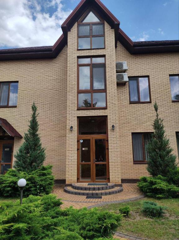 a brick house with a large glass door at Admiral in Koblevo