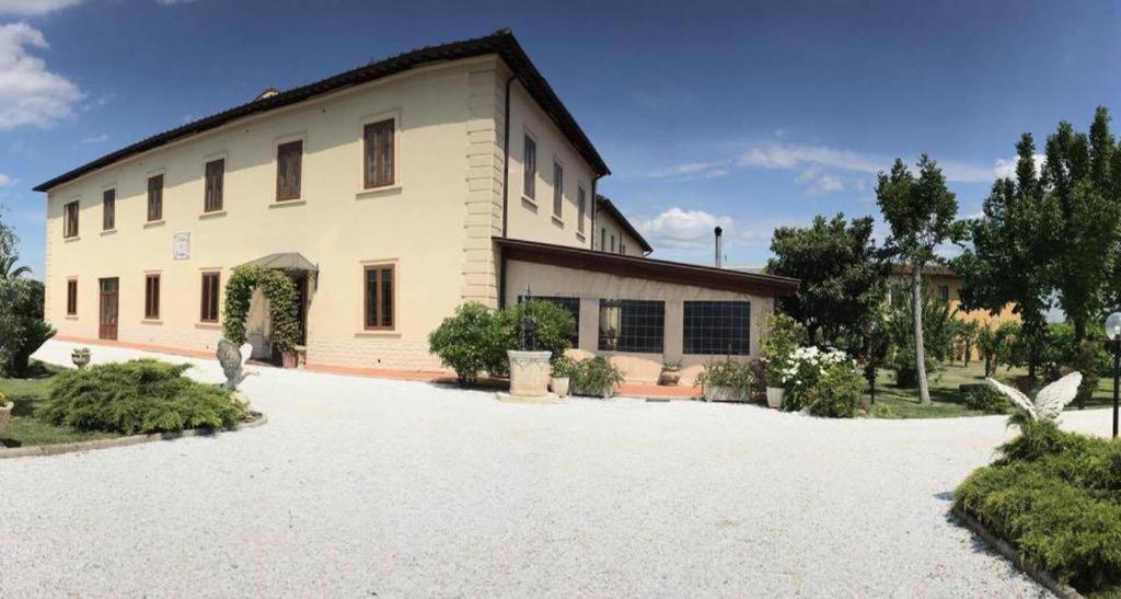 a large white building with a driveway in front of it at La Rosa Garden in Campi Bisenzio