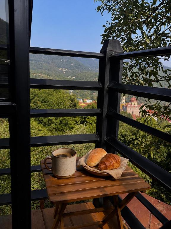 a table with a cup of coffee and some bread at Cielito Querido in Mineral del Chico