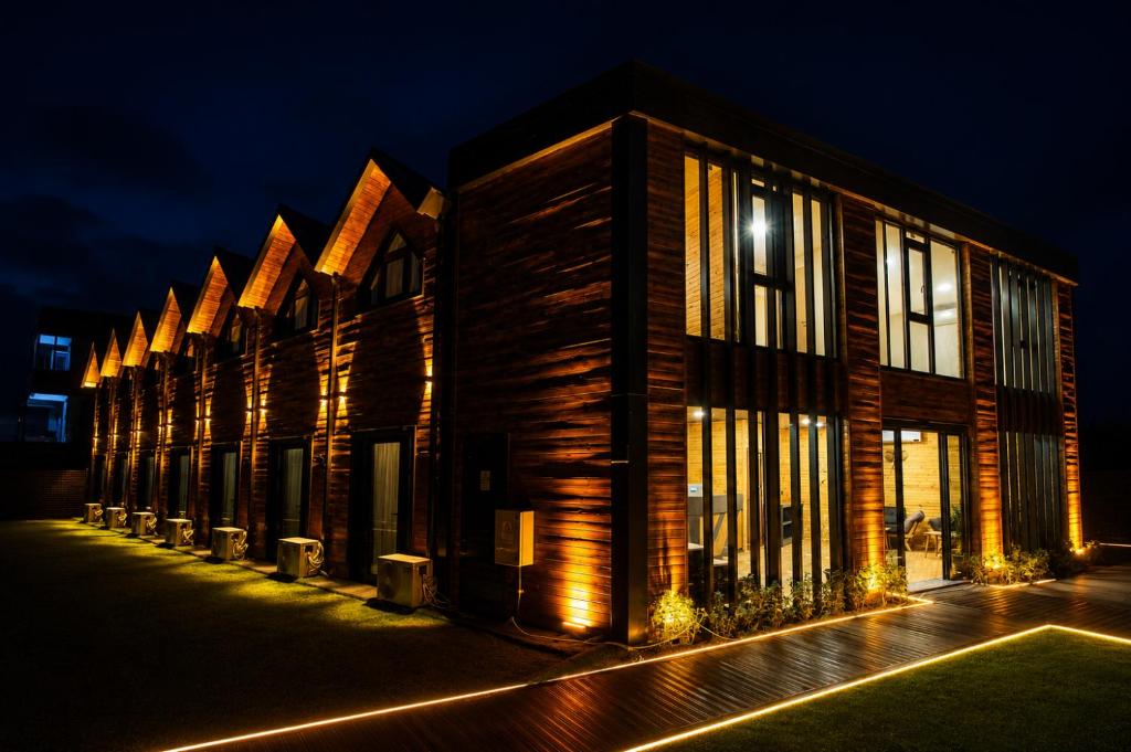 a row of wooden buildings at night at City Bungalow Hotel in Edirne