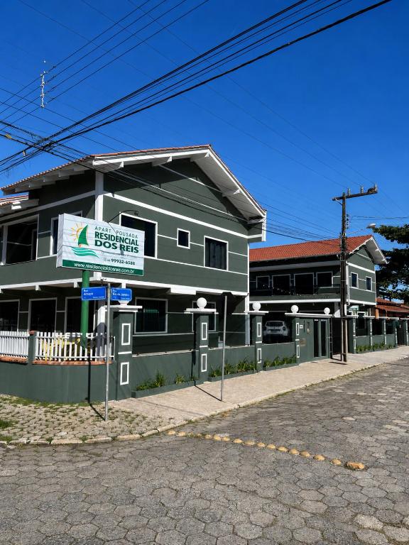 a building with a sign in front of it at ApartPousada Residencial dos Reis in São Francisco do Sul