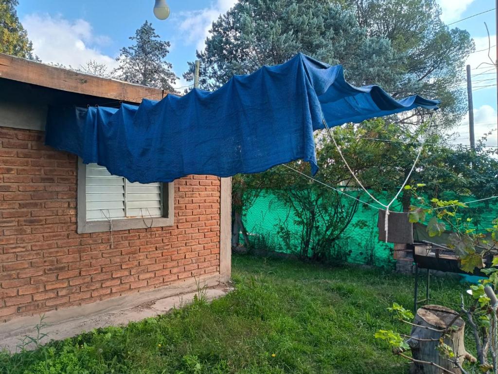 a blue umbrella outside of a house at Los Nonos in Perdriel
