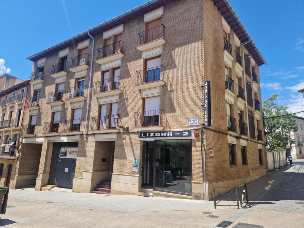 a large brick building on a city street at Hostal Lizana 2 in Huesca