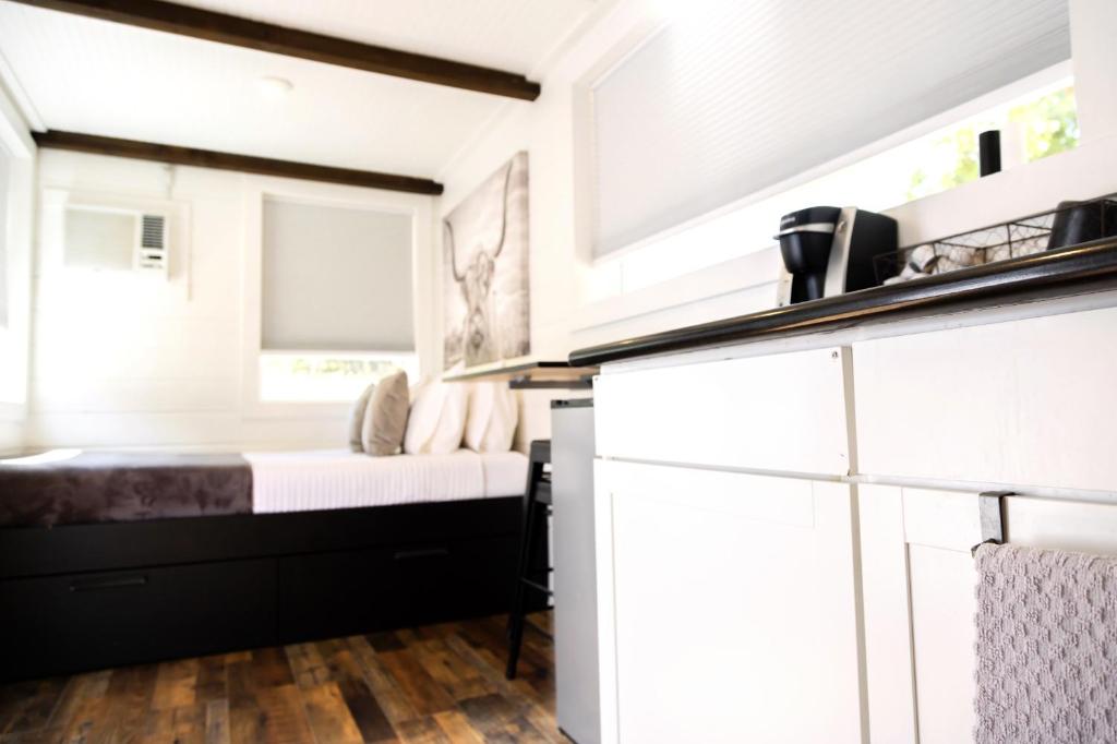 a small bedroom with a bed and a kitchen at NEW! Cozy Container Home at Cliffside #4 in Orderville