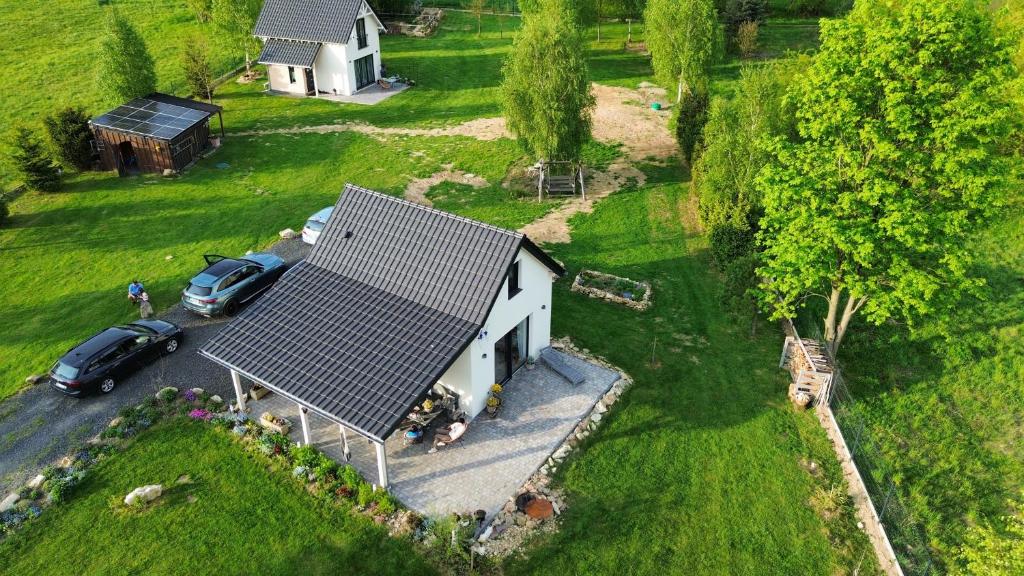 an aerial view of a white house with a roof at Cudne Manowce ogrodzony domek na wyłączność wśród ciszy i natury u stóp Gór Izerskich in Giebułtów