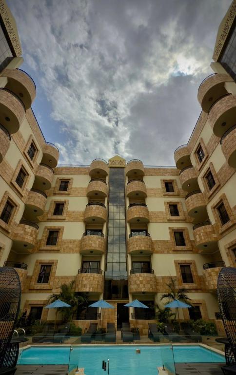 a large building with a pool in front of it at Lanai Hotel فندق لاناي in Jeddah