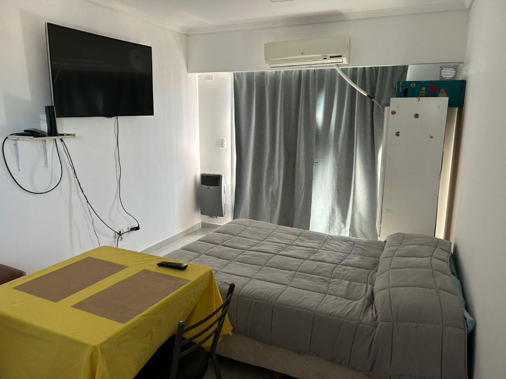 a bedroom with a bed and a table and a television at Shackleton in Wilde