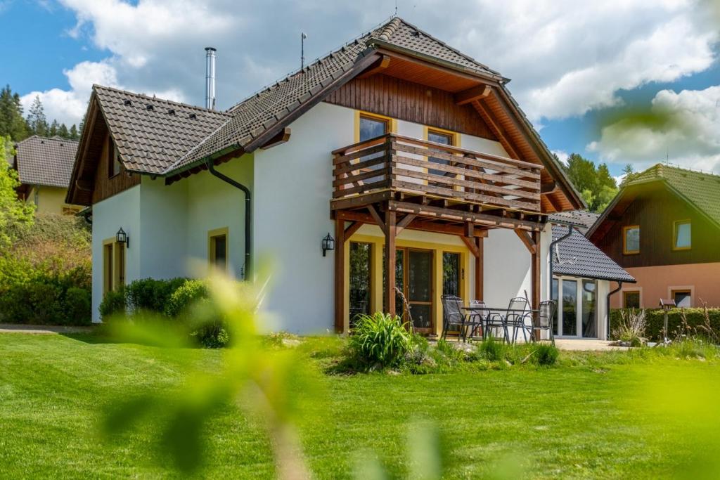 a house with a wooden roof at Villa Gamma - Lipno Home in Lipno nad Vltavou