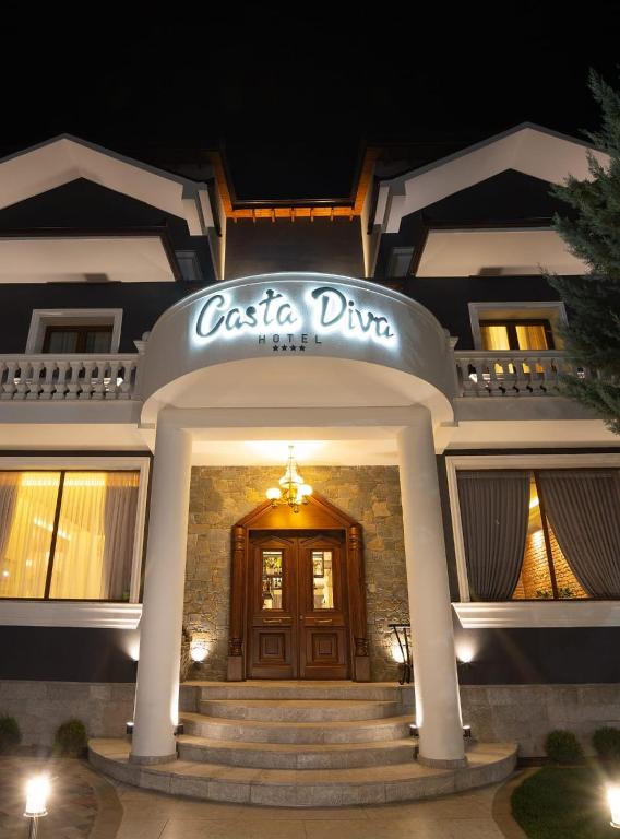 a building with a casita dinem sign on top of it at Casta Diva Boutique Hotel in Korçë