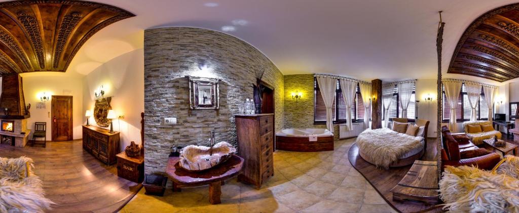 a large living room with a large stone fireplace at Momini Dvori Boutique Guest House in Bansko