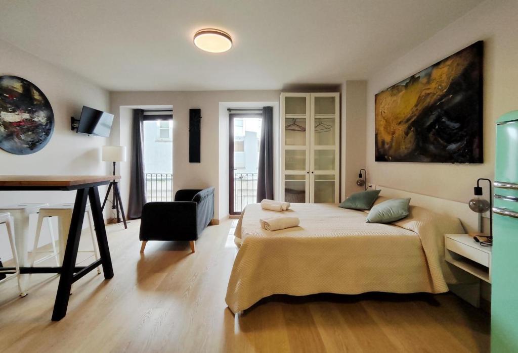 a bedroom with a bed and a desk in it at Luxury apartamento Muralla de Lugo 1.2 in Lugo