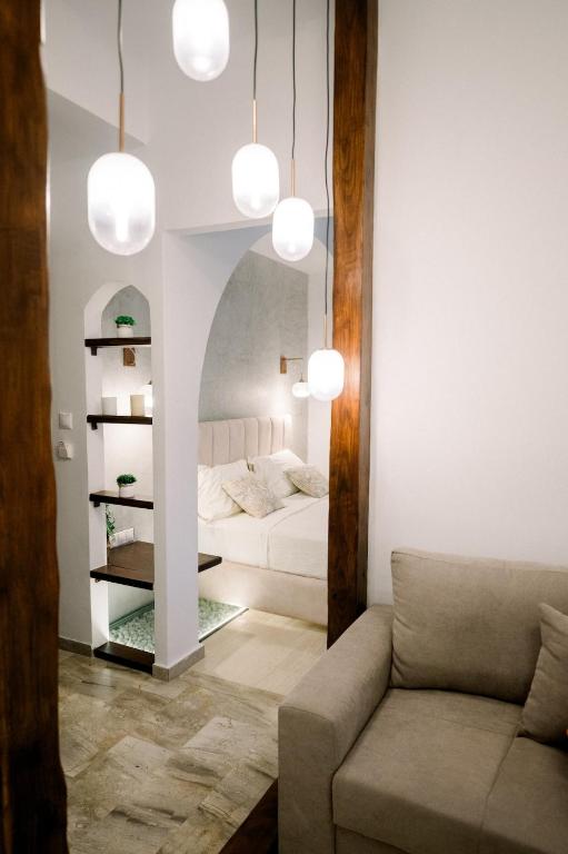 a living room with a bed and a couch at Benjamin Luxury Suite by The Eustas in Pylos