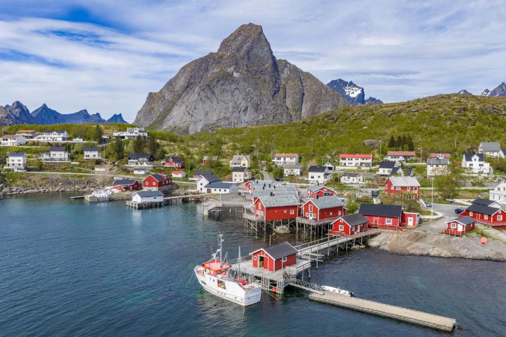 a boat is docked at a dock in the water at Reine seaview cabin in Reine