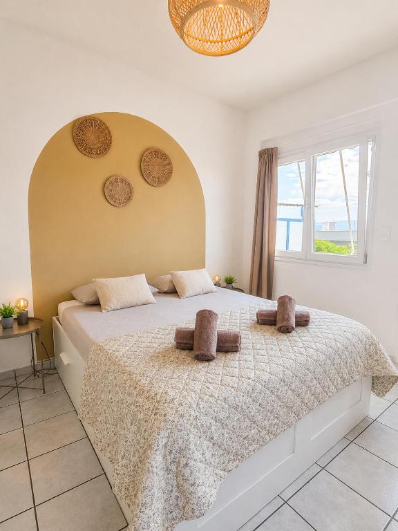 a bedroom with a large bed with two pillows on it at Tolo at sea - Emma in Tolo