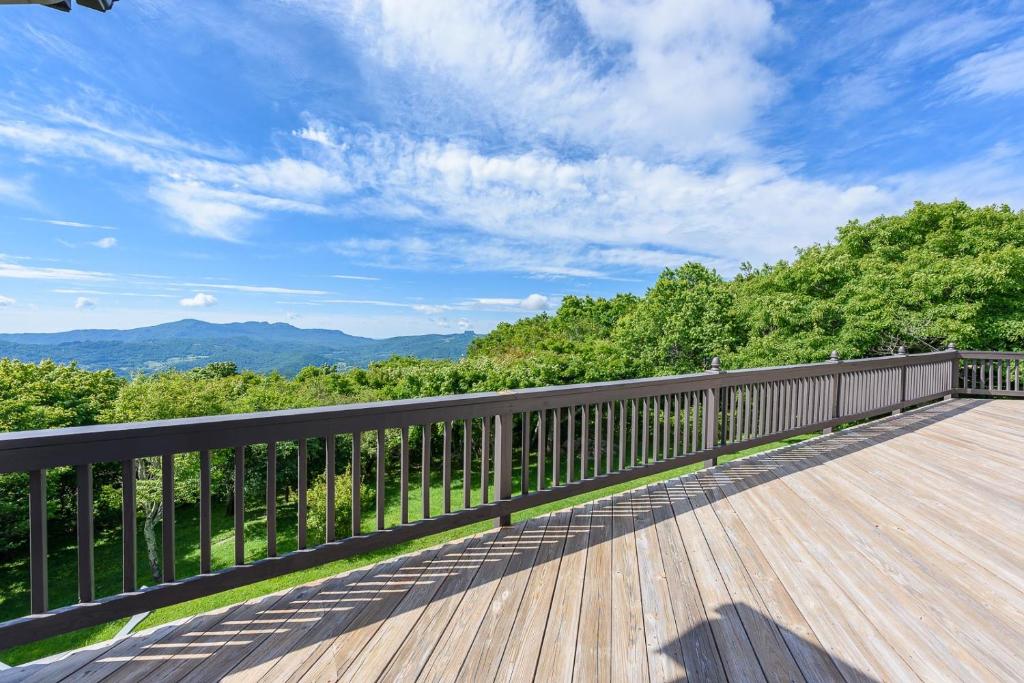 a wooden deck with a view of the mountains at Elderberry Escape in Beech Mountain