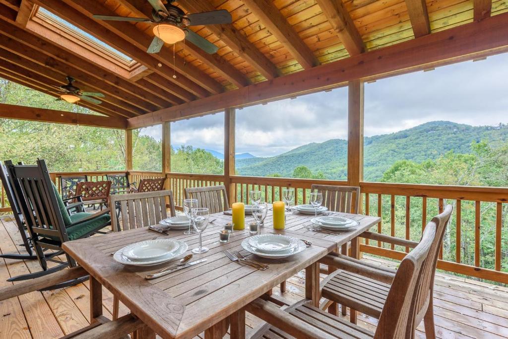 a wooden table on a deck with a view of mountains at Valle View in Valle Crucis