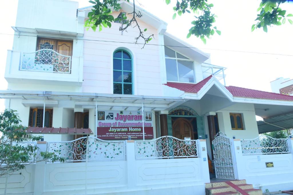 a white house with a sign in front of it at jayaram Home Palace Chittoor in Chittoor
