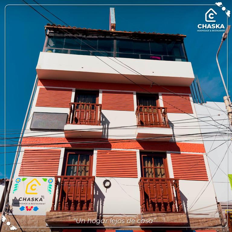 a tall building with balconies on the side of it at Chaska Backpackers & Rooms in Ayacucho