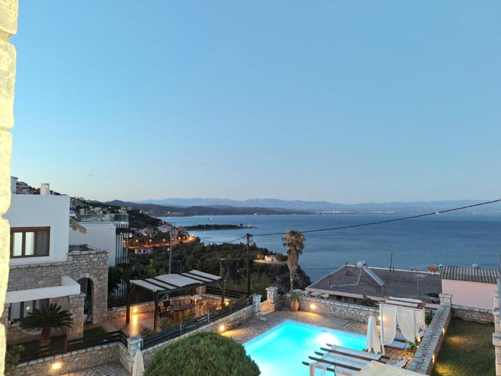 a villa with a swimming pool and a view of the ocean at Malvazios Villas with sea and pool view in Gythio