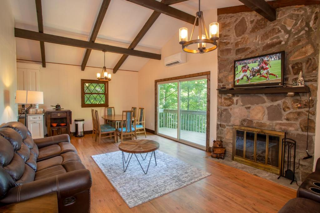 a living room with a couch and a fireplace at Fern Cottage in Beech Mountain