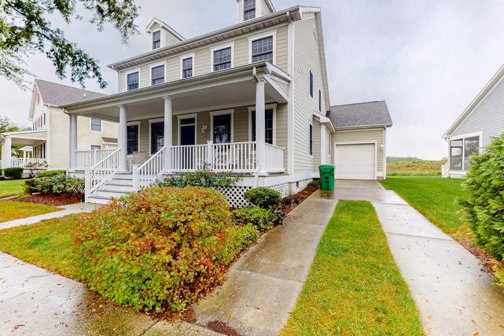 a white house with a porch and a driveway at Bear Trap Dunes - 182 Willow Oak in Ocean View