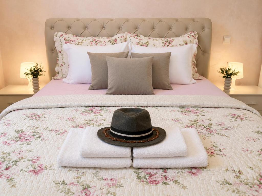 a hat sitting on top of a bed with towels at Villa Mare Apartments in Tivat