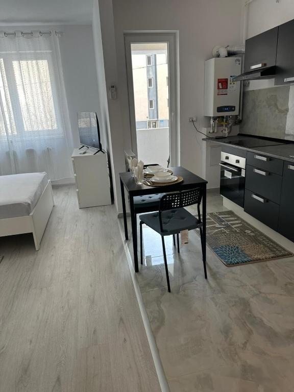 a kitchen with a table and a dining room at Apartment complex in Roşu