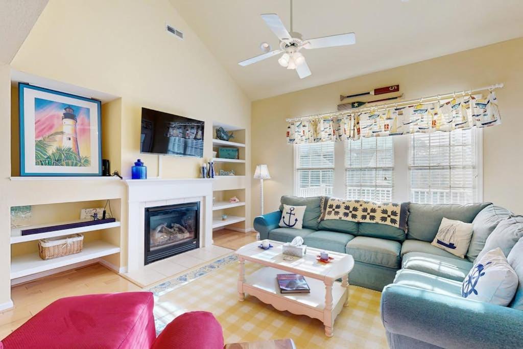a living room with a couch and a fireplace at Bear Trap Dunes - 214H October Glory Ave in Ocean View