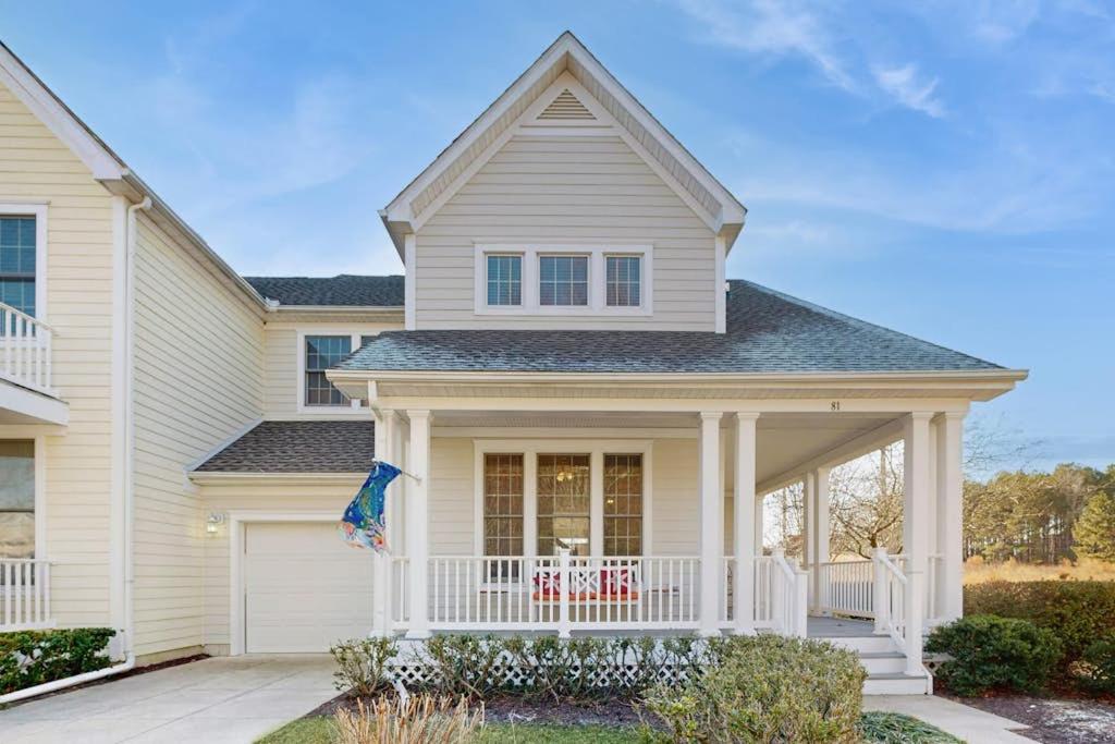 a white house with a porch and a balcony at Bear Trap Dunes - 81 Tulip Poplar in Ocean View