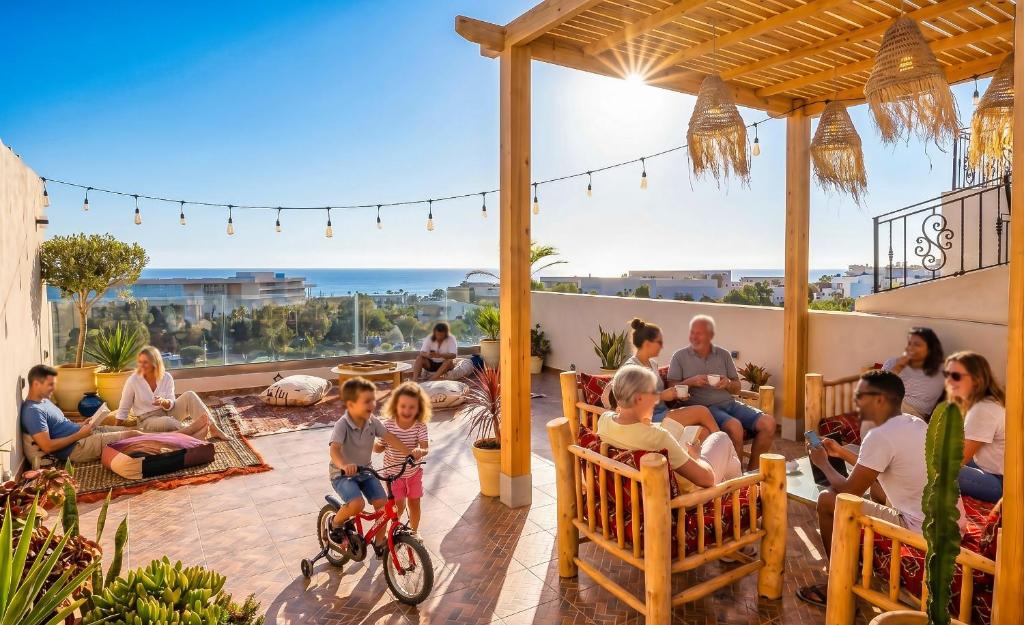 a group of people sitting on a patio at White Majorelle Casa Grande in Tamraght Ouzdar