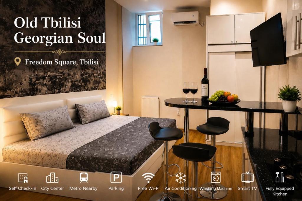 a room with a bed and a table with chairs at Old Tbilisi Georgian Soul in Tbilisi City