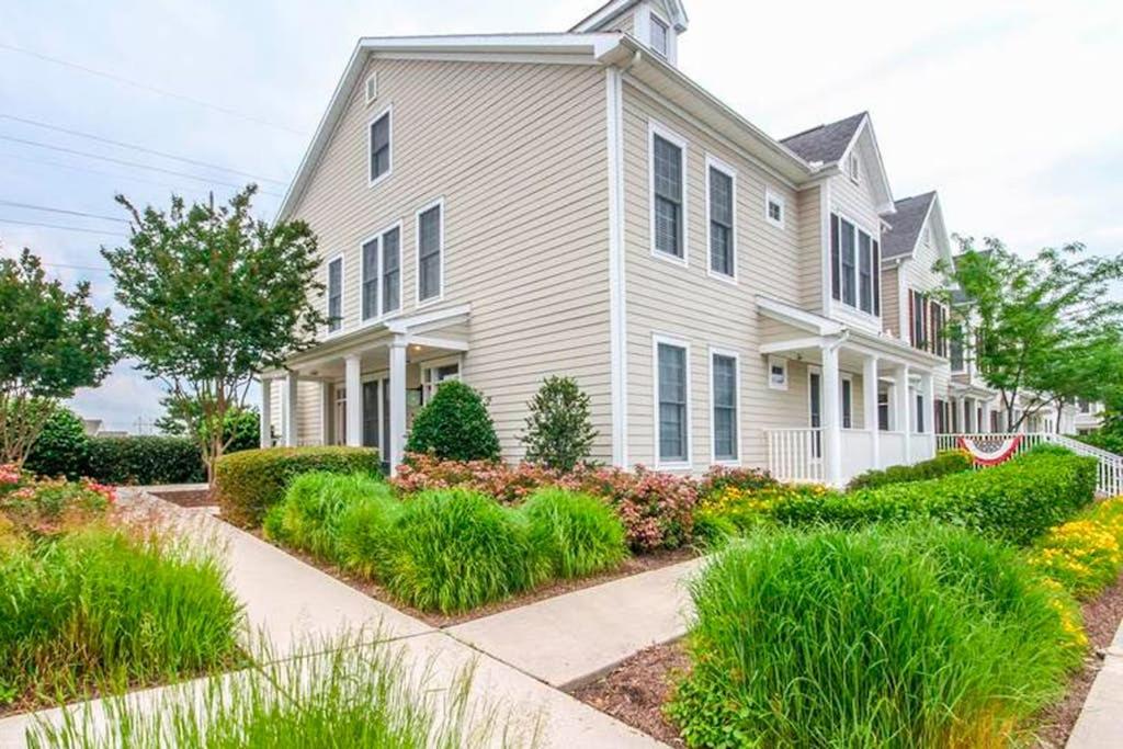 a white house with landscaping in front of it at Bear Trap Dunes - 126B October Glory Ave in Ocean View