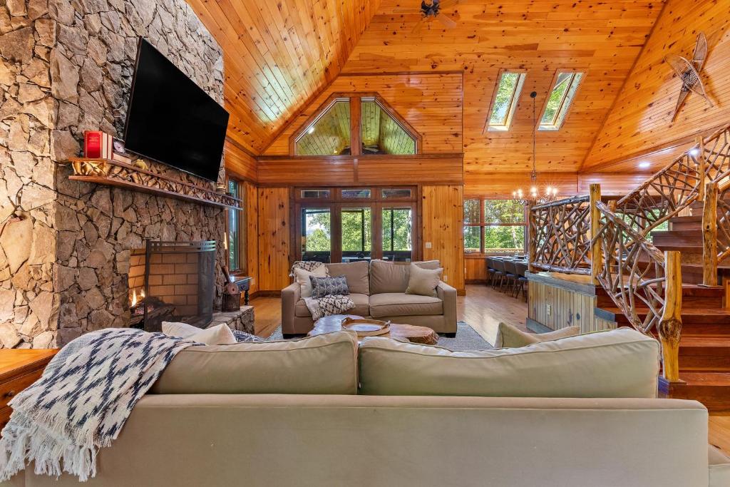 a living room with a couch and a stone wall at Chimney Island in Blowing Rock
