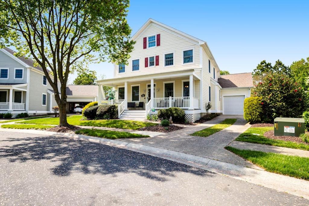 a white house with a tree in the driveway at Bear Trap Dunes - 28 October Glory in Ocean View