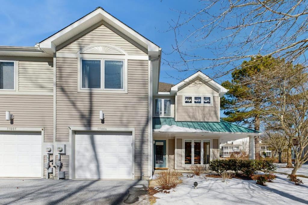 a house with two garage doors in front of it at Sea Colony - 55006 Pine View Rd in Bethany Beach